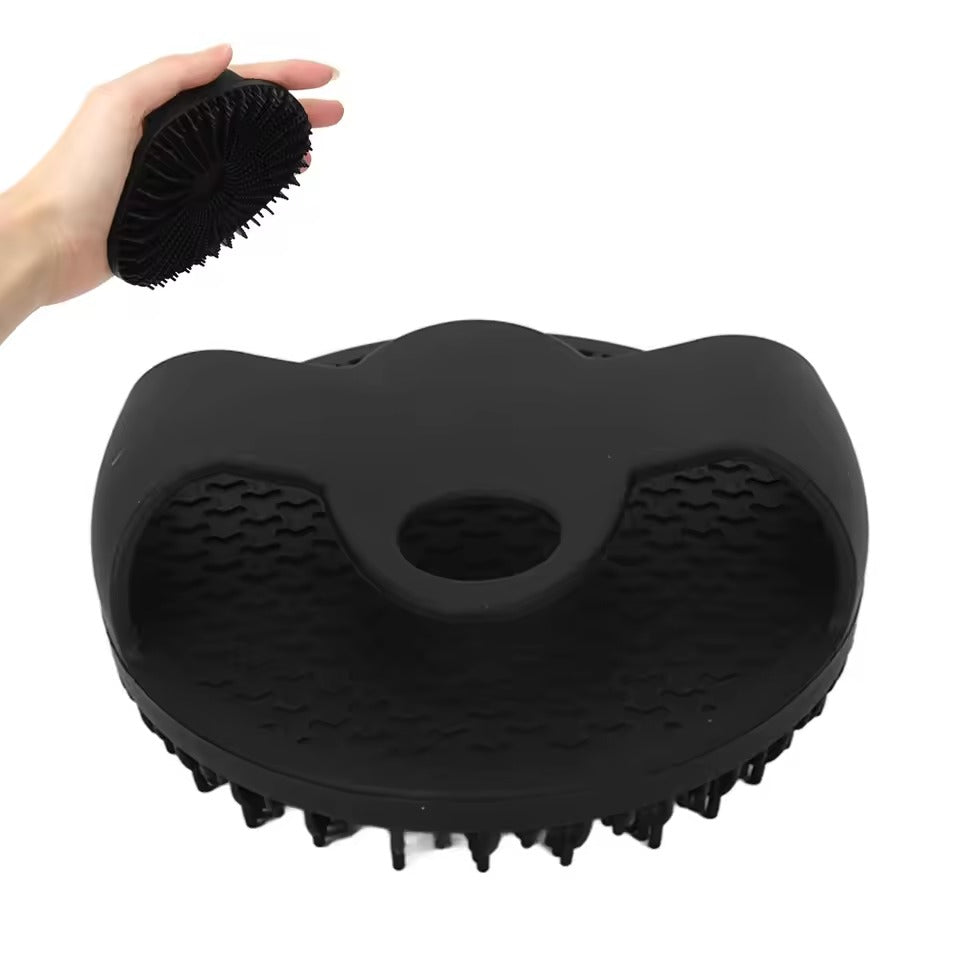 Black silicone bath body brush showing integrated hand grip and textured bristles