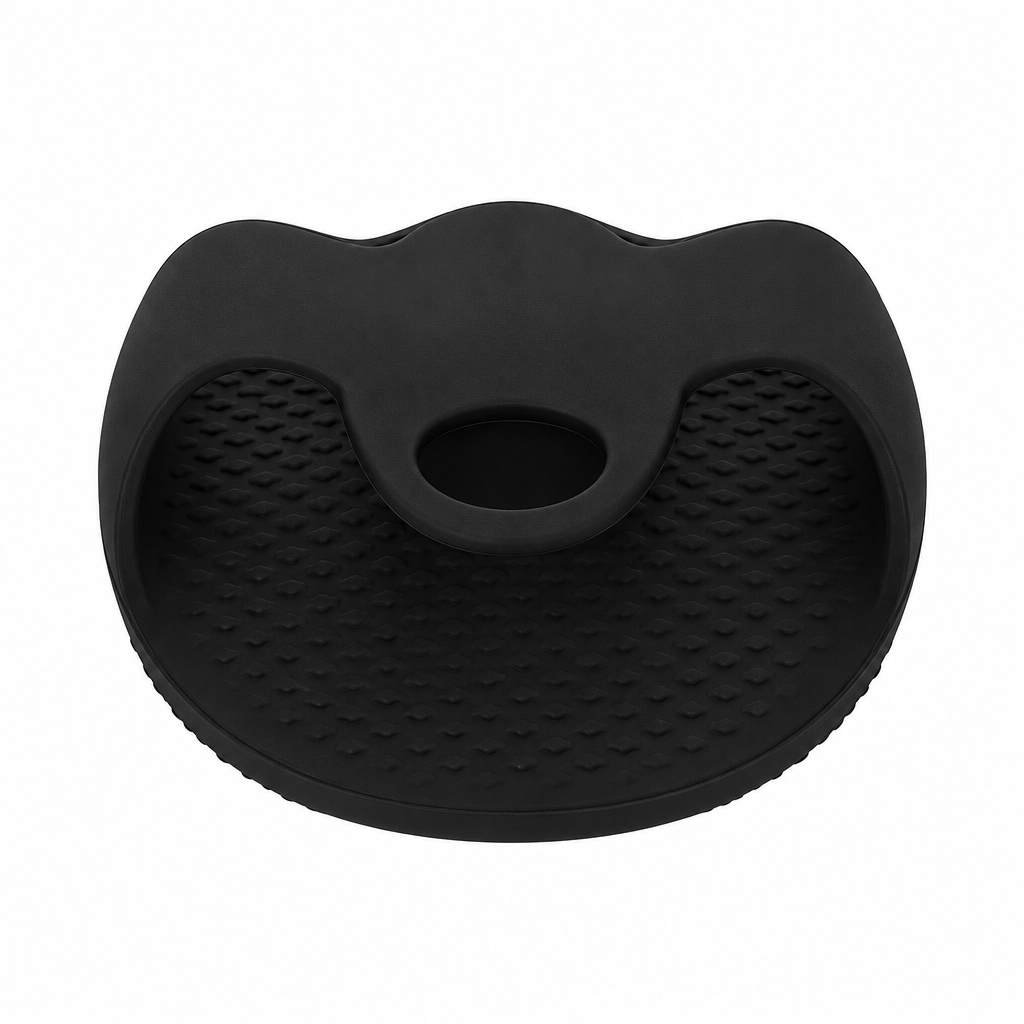ear view of the black silicone bath body brush showing its integrated hand grip.